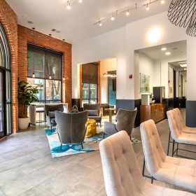 Clubhouse spacious lounge with seating, modern decor, and easy access to the street