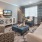 Large living room with large open windows for plenty of natural light.